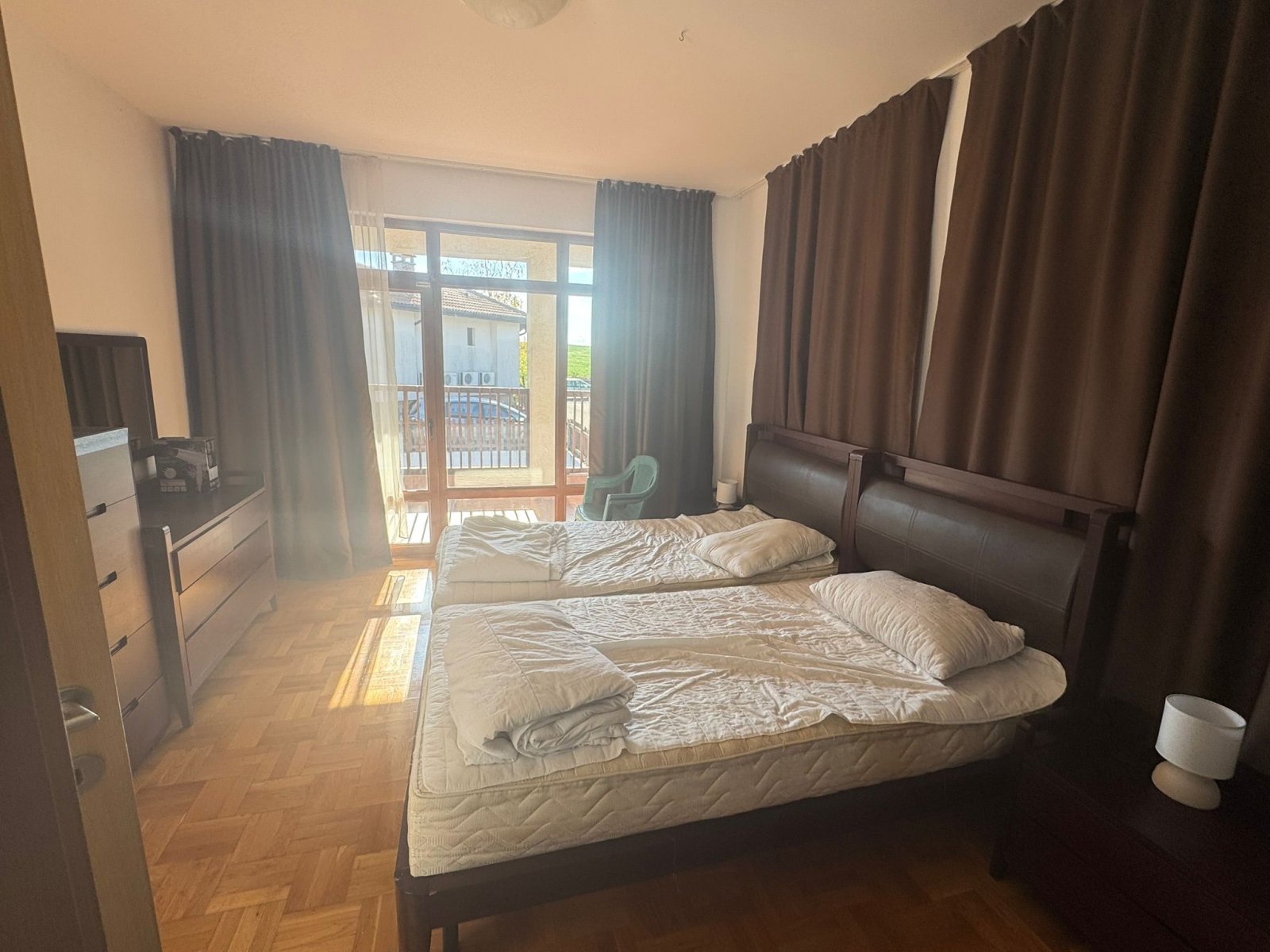 Brightly lit bedroom with balcony access - parquet and comfort in perfect harmony